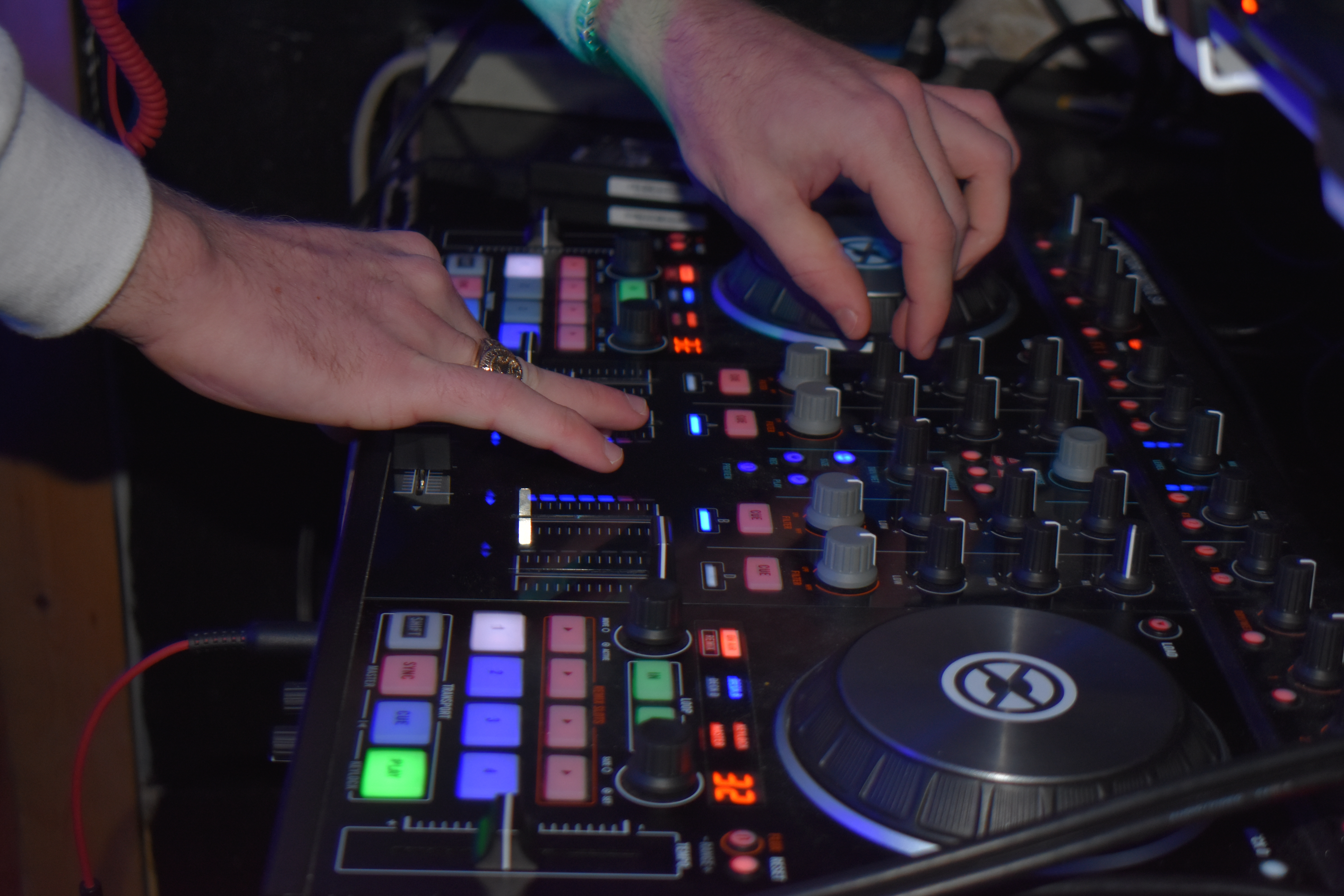 an image of people in a room with DJ equipment